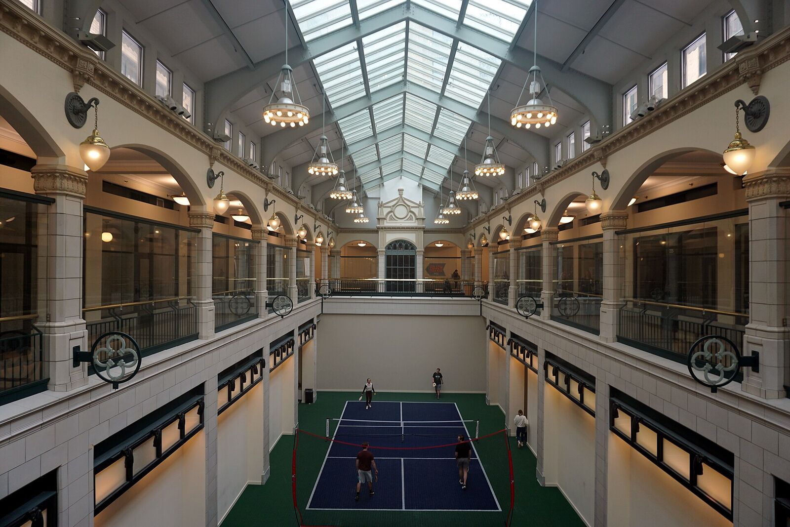 One indoor pickleball court under the skylights of an old shopping arcade